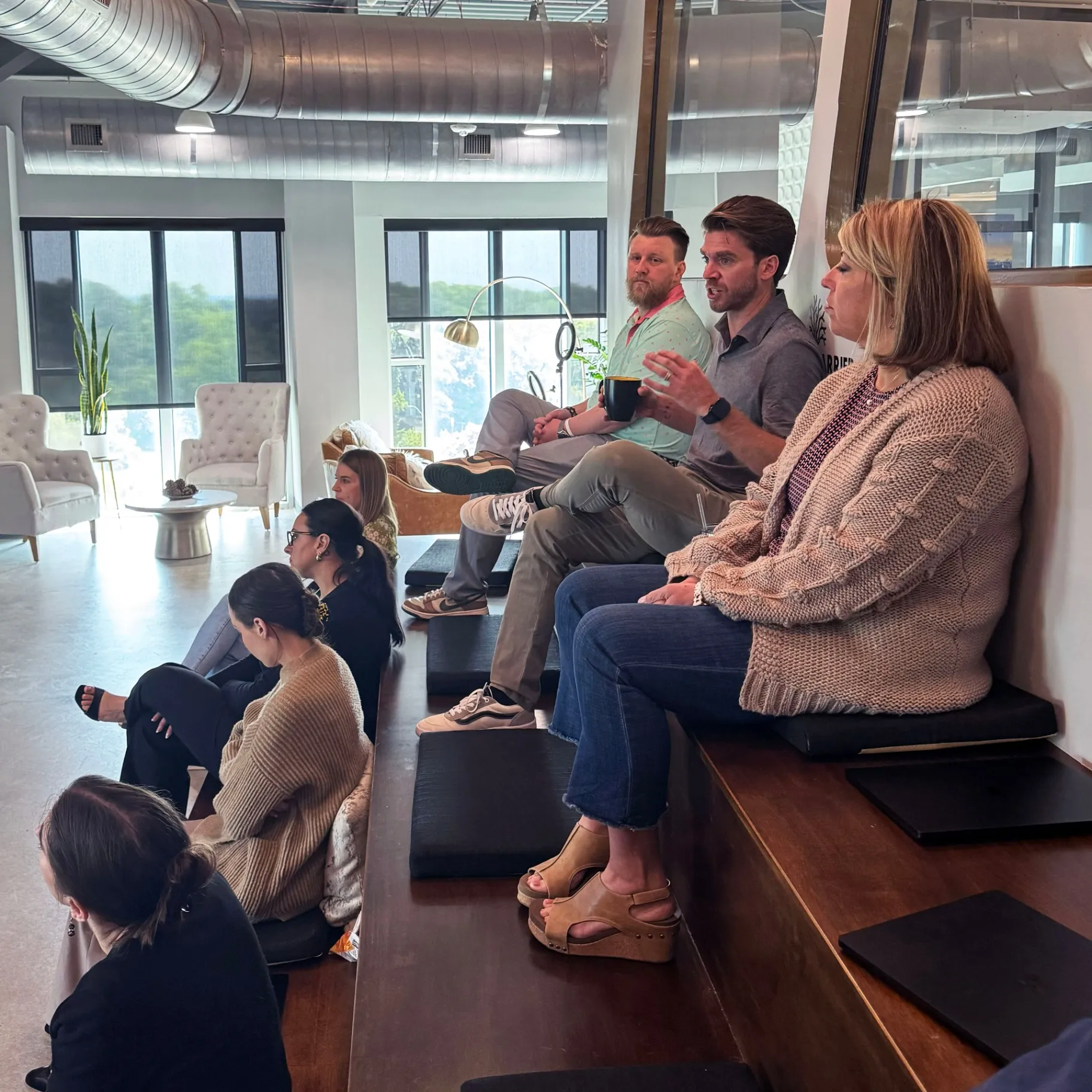 Team members gathered in modern office meeting space